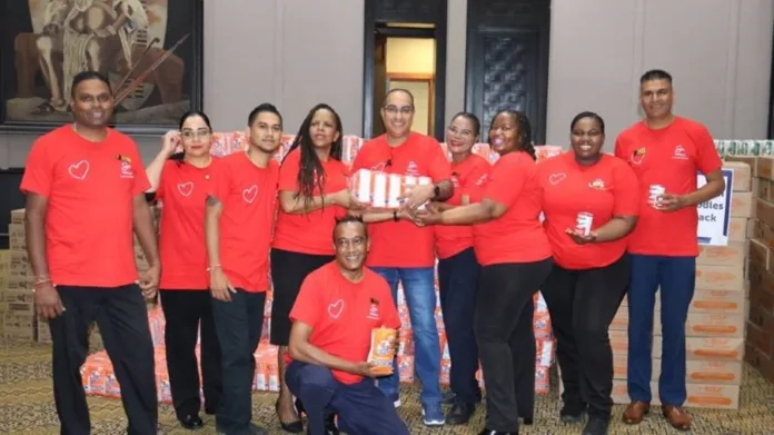 Leading by example, Virath Gobrie guides the Sibaya team as they spend the day packing for the community
