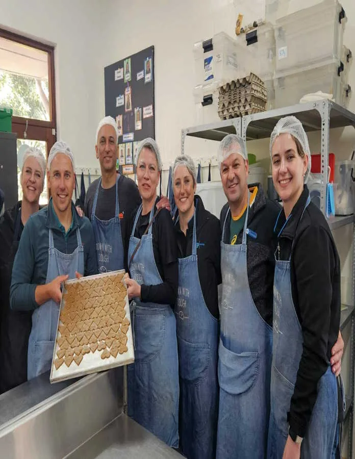 Members of the SCP Radiology team spent Mandela Day in the kitchen at Down with Dough, a Cape Town bakery that provides meaningful employment for adults with intellectual and developmental disabilities. The team helped bake the bakery's signature gluten-free brownies and donated supplies. From left: Adele Bartels, Francois Joubert, Dr Himal Gajjar, Madelein de Wet, Maryke Smith, Nico Basson and Alana Lategan.